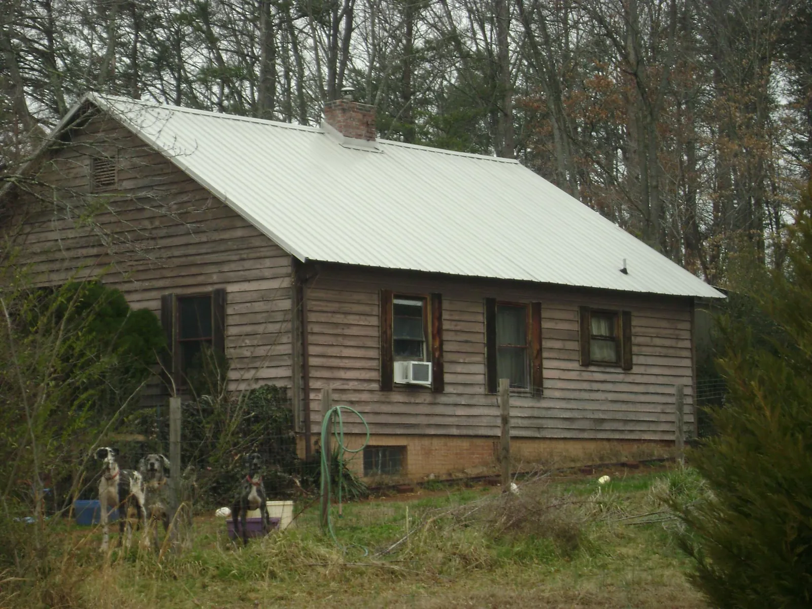 White metal roof on an old wood sided farmhouse, from a Metal Roof Installation job in Alvo